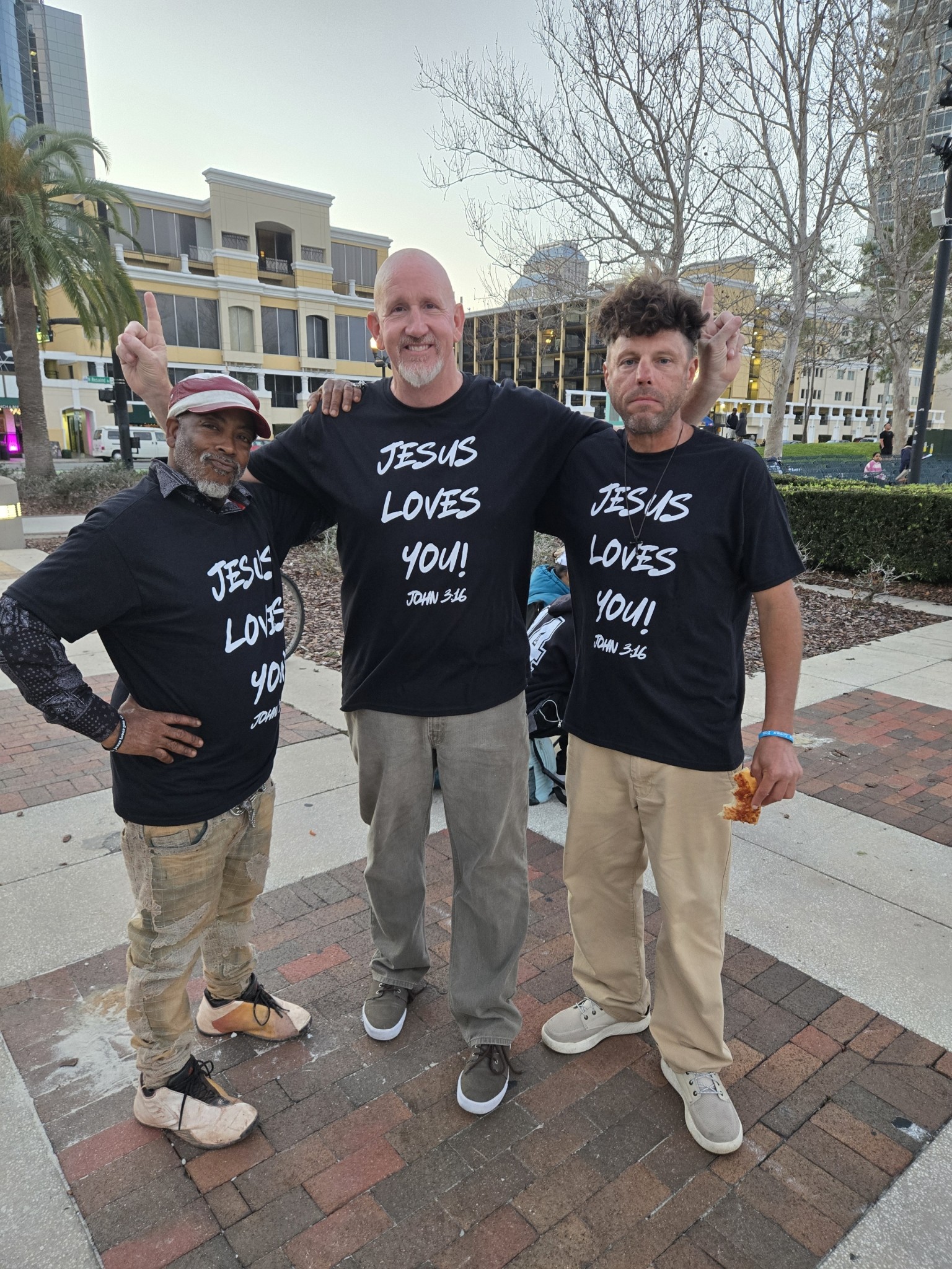 Eric Schwalbach and team with Jesus Loves You signs